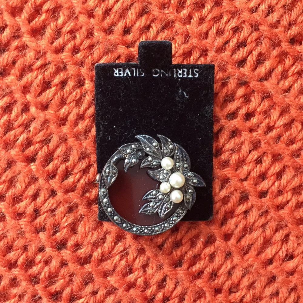 Brooch with a free scarf.